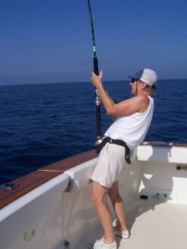 Pat Woodard is a happy angler while fighting a sailfish baitfish aboard her boat Christina Lynn between Papanoa and Acapulco. January, 2007.